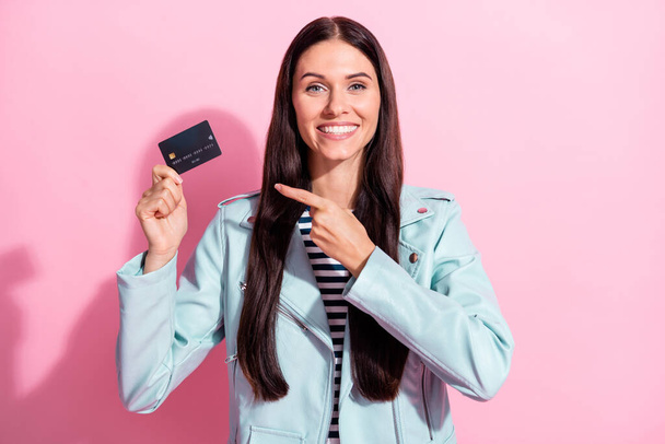 Photo of trendy brown haired woman point credit card recommend isolated on pastel pink color background - Φωτογραφία, εικόνα