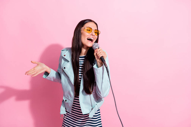 Photo of funky attractive young lady singer karaoke hold mic isolated on pastel pink color background - Foto, Imagem
