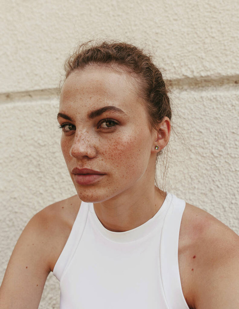 Portrait of a beautiful and cute girl with freckles in the street - Photo, Image