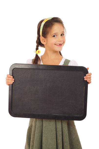 Little schoolgirl with empty chalkboard - Фото, изображение