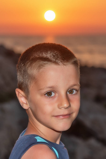 A nice boy on the beach at sunset - Photo, Image