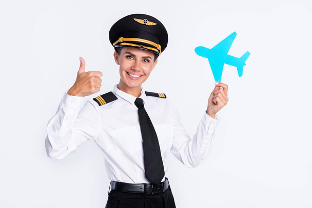 Photo of pretty girl hold paper plane raise thumb up wear aviator hat uniform isolated white color background - Φωτογραφία, εικόνα