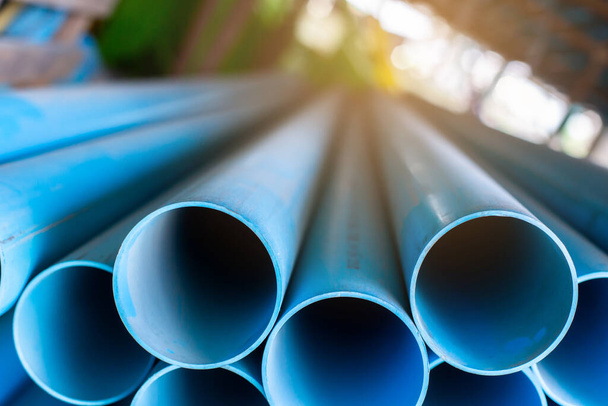 Close up to blue plastic pipe background, PVC pipes stacked in warehouse,  PVC water pipes used for construction - Photo, Image