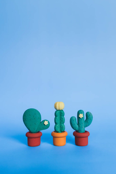 Cactus shaped erasers on a blue light background. Teaching concept. Copy-space - Photo, Image
