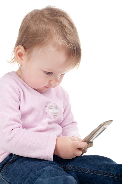 Little girl plays with mobile phone isolated - Foto, imagen