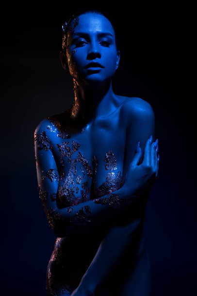 Nude woman with body art under neon illumination - Photo, Image
