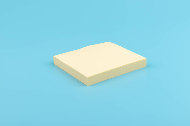 blank square yellow reminder paper notes on blue texture background.  - Фото, изображение