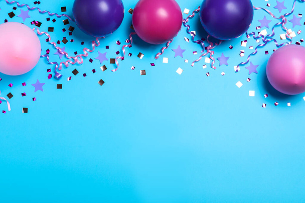Many balloons and confetti on light blue background, flat lay with space for text. Birthday decor - Foto, Imagem