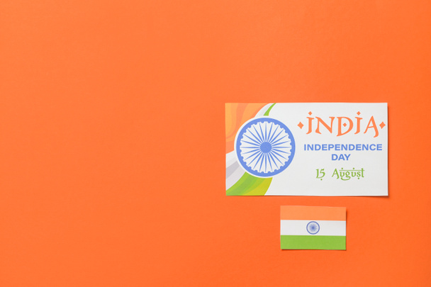 Drapeau indien et carte de voeux pour la fête de l'indépendance sur fond de couleur - Photo, image
