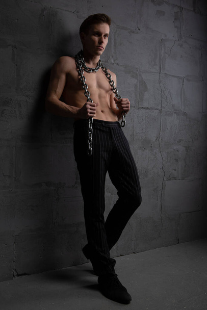 Young athletic handsome man with chains around his neck - Photo, image