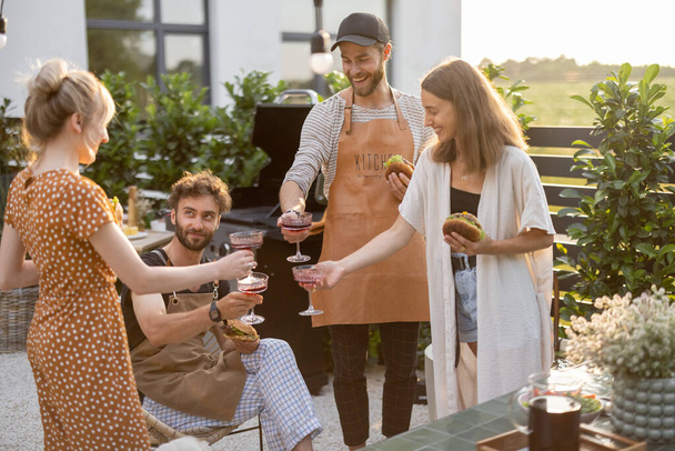 Friends celebrating with alcohol drinks outdoors - Photo, image