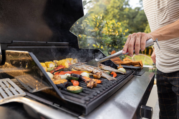Grilling fish and corn on a grill - Fotoğraf, Görsel