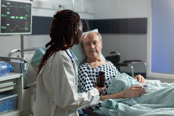 Senior man breathing with help from oxygen tube - Photo, Image