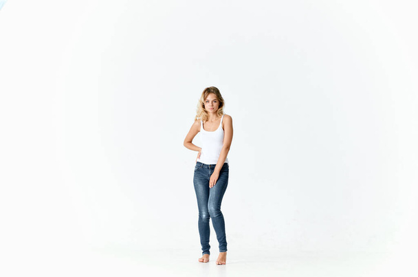 cheerful woman woman in jeans barefoot dancing on the floor - Photo, Image
