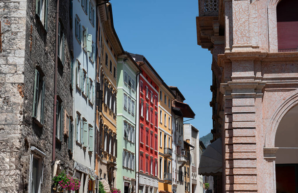 Trento, Italy, June 2021. Beautiful view of one of the streets of the historic center characterized by brightly colored facades. Beautiful summer day. - Photo, Image