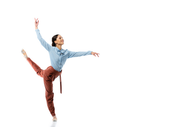 Cheerful professional ballerina dancing on white background  - Фото, изображение