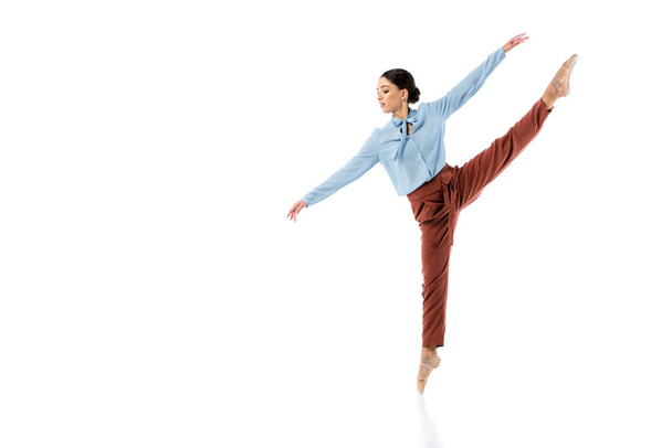 Side view of classical dancer exercising on white background  - Foto, imagen
