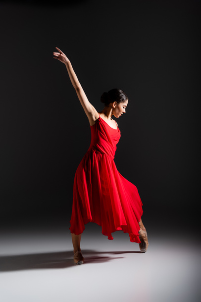 Boční pohled na mladé balerína tanec na černém pozadí  - Fotografie, Obrázek