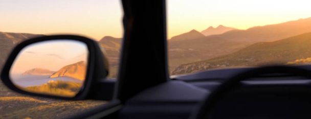 Panoramic view out of a car window at sunset in the mountains 3d render - Foto, imagen