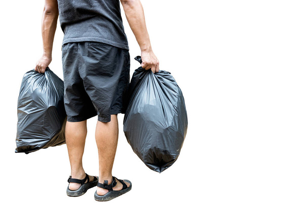 Назад вид, людина тримає чорний мішок сміття, що містить сміття в руках, два пластикові пакети сміття для відділення переробки та загальних відходів, сортування відходів для утилізації, ізольовані на білому тлі
 - Фото, зображення