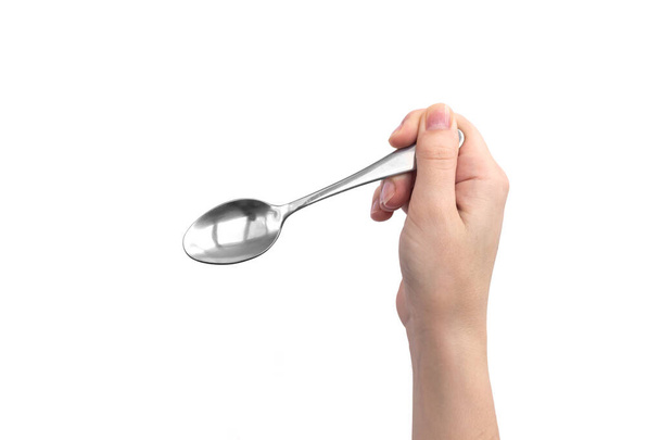 Hand with steel kitchen spoon, isolated on a white background  - Фото, зображення
