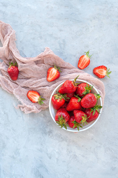 Fresh ripe strawberries in a bowl on grey background. - Фото, зображення