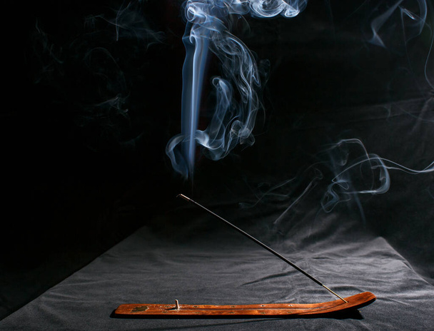palo de incienso indio con humo sobre fondo negro - Foto, Imagen