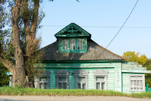 Yaroslavl. Russia. September 2020. Old rustic carved wooden house in green. - Photo, Image