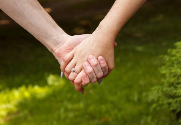 hombre y mujer tomados de la mano. las manos de cerca. al aire libre en día de verano - Foto, Imagen