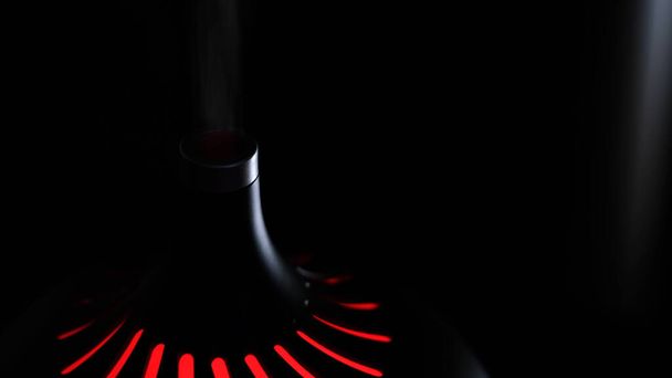 Close up of an air humidifier turned on in a dark room with light flare. Concept. Skin moisturising, home appliances for the comfort of life. - Photo, Image