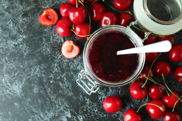 Cherry jam and ingredients on black smokey background - Foto, Imagem