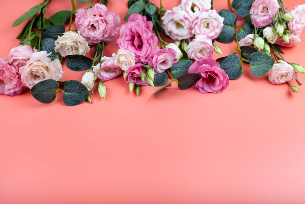 Bouquet of flowers on a pink background. Beautiful eustomas. - 写真・画像