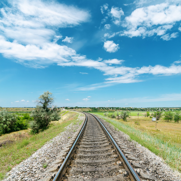 railway in green landscape and white clouds in blue sky - Фото, изображение