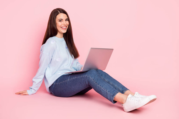 Full size profile photo of nice optimistic brunette hairdo lady sit type laptop wear shirt jeans isolated on pink background - Fotoğraf, Görsel