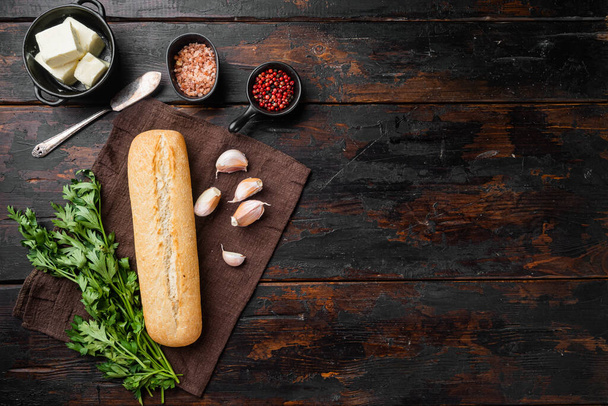 Homemade tasty bread with garlic, and herbs ingredients set, on old dark  wooden table background, top view flat lay, with copy space for text - Φωτογραφία, εικόνα