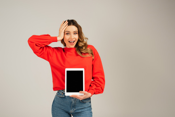 excited woman holding digital tablet with blank screen isolated on grey  - Foto, Imagem