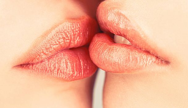 Lip care and beauty. Closeup of beautiful young woman healthy lips. Lesbian couple kiss lips. Passion and sensual touch. Closeup of women mouths kissing. Two beautiful sexy lesbians in love - Foto, imagen