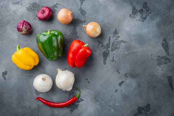 Collection of vegetables Bell pepper and onion, on gray background, top view flat lay with copy space for text - Foto, imagen