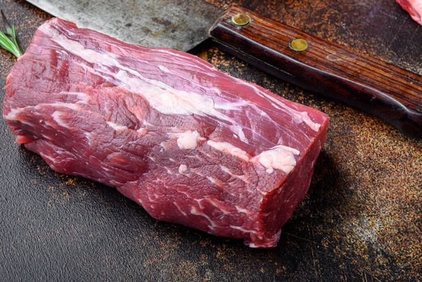Gourmet portion of raw fresh marbled beef fillet set, on old dark rustic background - Foto, afbeelding
