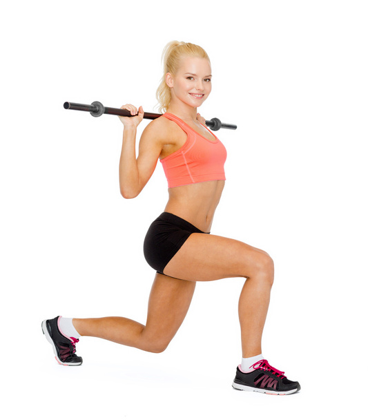 smiling sporty woman exercising with barbell - Fotografie, Obrázek