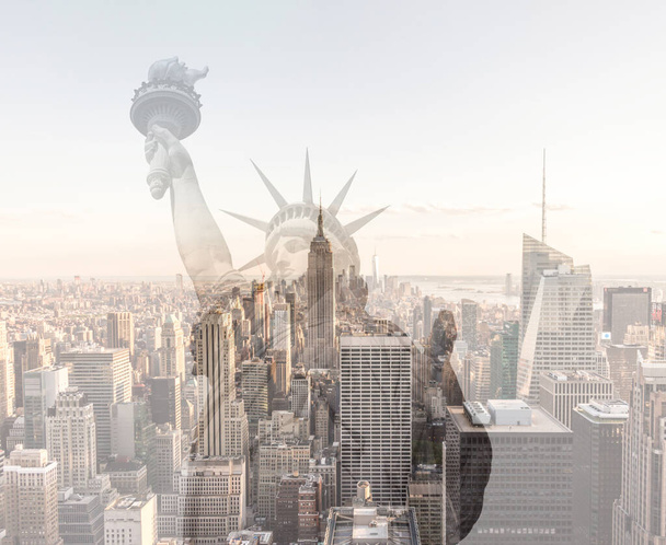 Double exposure of Manhattan skyline in new york city with statue of liberty silhouette - Photo, Image
