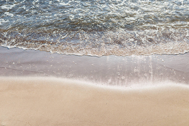 Размытая волна моря на песчаном пляже.. - Фото, изображение