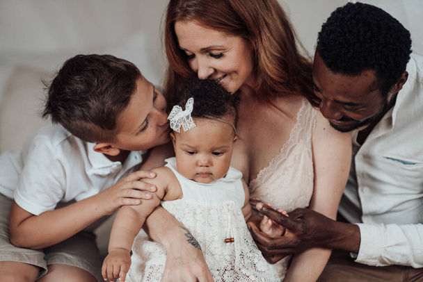 smiling young interracial family with kids - Photo, Image