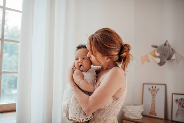 happy woman holding her mixed race daughter  - Foto, imagen