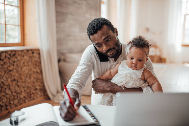 little girl sitting with father during his work from home - Photo, Image