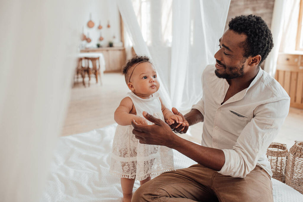 Father Baby Connection. heureux noir l'homme collage avec mignon bébé enfant à la maison - Photo, image