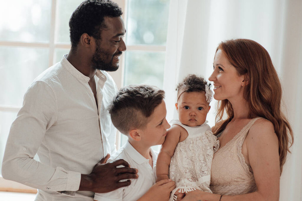 smiling young interracial family with kids - Foto, afbeelding