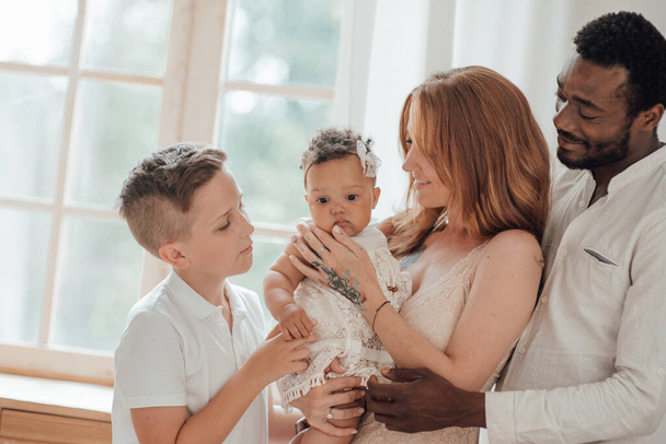 portrait of happy interracial family with daughter and son - Photo, image