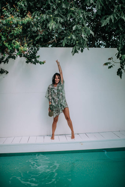model posing with pineapple near swimming pool  - Zdjęcie, obraz