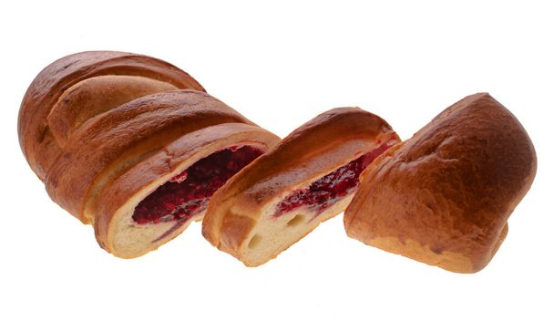 Confectionery product, bun in the form of a roll, two pieces are cut from one edge, on a white background - Photo, Image